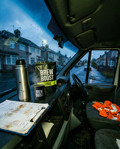 Brew Boost on the dashboard of a work van